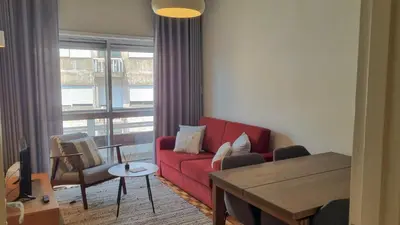 a living room with a red couch and a table at Oporto Downtown in Porto