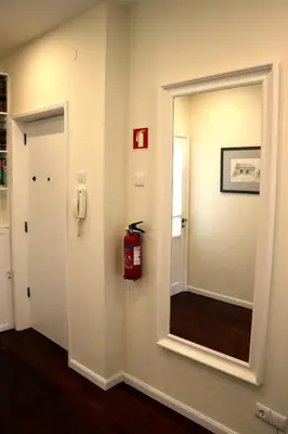 a room with a mirror and a fire extinguisher at Porto Patricio Apartments in Porto