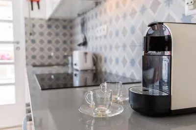 a coffee maker sitting on a counter in a kitchen at Porto Haven - Terrace Penthouse in Downtown in Porto