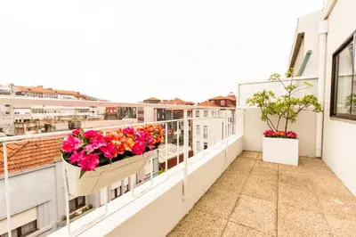 a balcony with flowers inpots on a building at Porto Haven - Terrace Penthouse in Downtown in Porto