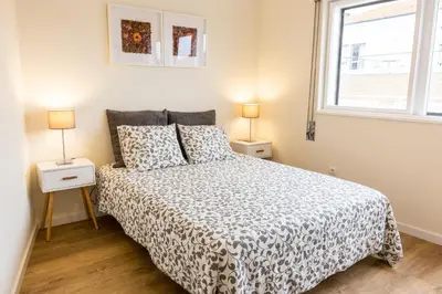 a bedroom with a bed and two lamps on two tables at Porto Haven - Terrace Penthouse in Downtown in Porto