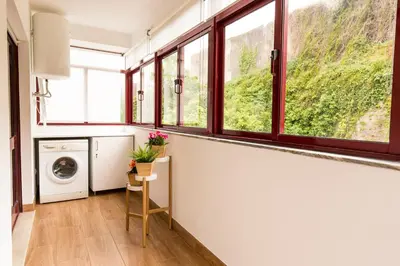 a laundry room with windows and a washer and dryer at Porto Haven - Marquês Downtown in Porto