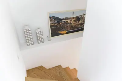 a room with a picture on the wall and wooden floors at APOSENTUS - Your home at Pinheiro's Residence in Porto