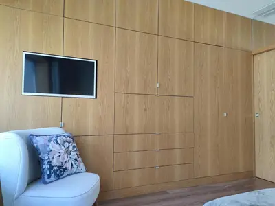 a living room with a tv and a white couch at Trindade Apartments in Porto