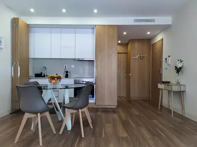 a kitchen with a table and chairs in a room at Trindade Apartments in Porto
