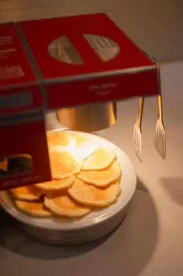 a pile of chips on a plate with a box at Moov Hotel Porto Centro in Porto