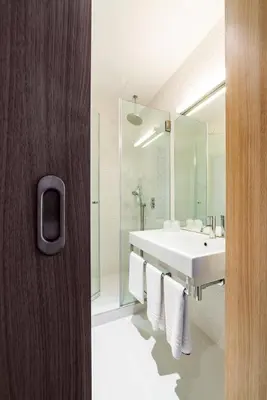 a bathroom with a white sink and a mirror at Moov Hotel Porto Centro in Porto