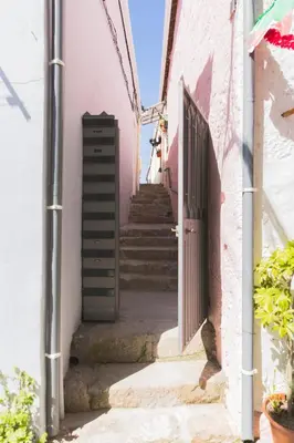 an alley with stairs and a door in a building at APOSENTUS - Your home with a remarkable view in Vila Nova de Gaia