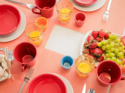 a table with plates of fruit and glasses of juice at CM Vintage Apartments in Porto