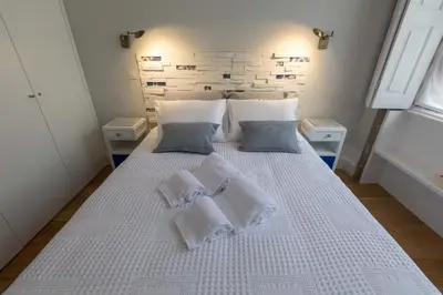 a bedroom with a white bed with towels on it at charm in C - Porto Center Apartment in Porto