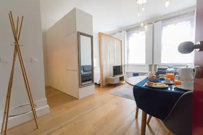 a living room with a dining table and a living room with a tv at charm in C - Porto Center Apartment in Porto