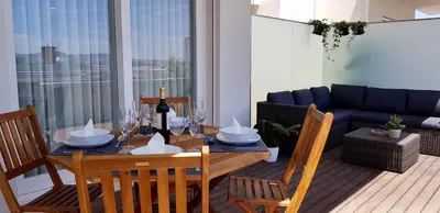 a dining table and chairs in a living room at Min Porto Inn in Porto