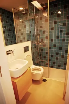 a bathroom with a toilet and a sink and a shower at Min Porto Inn in Porto