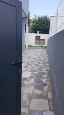 a door leading to a courtyard with a stone floor at Porto In Sight, 4 Kids in Vila Nova de Gaia