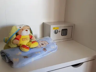 a stuffed teddy bear sitting on a pillow next to a microwave at Porto In Sight, 4 Kids in Vila Nova de Gaia