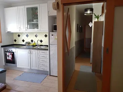 a kitchen with white cabinets and a sink at Porto In Sight, 4 Kids in Vila Nova de Gaia