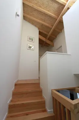 an attic hallway with white walls and wooden floors at Oporto City Cottage in Porto