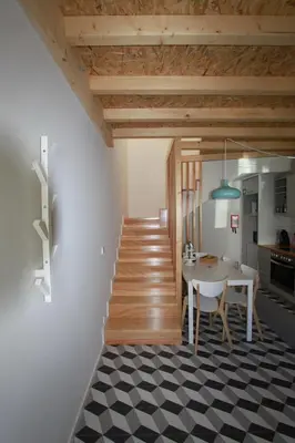 a kitchen and dining room with a table and a staircase at Oporto City Cottage in Porto