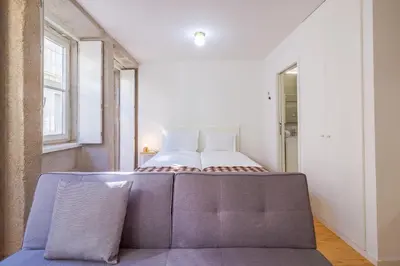 a bedroom with a bed and a couch in it at YOUROPO - The Tower in Porto
