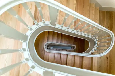 a spiral staircase in a room with wooden floors at Vitoria Studio Residence - Downtown in Porto