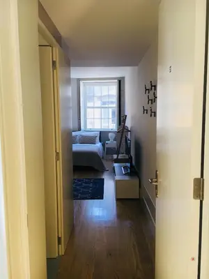 a bedroom with a bed and a couch and a table at Vitoria Studio Residence II - Downtown in Porto
