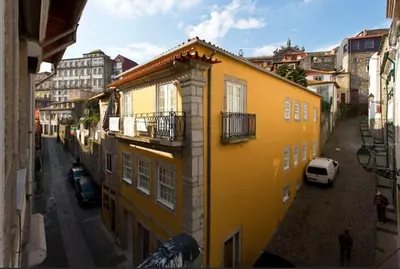 a yellow building on the side of a street at Vitoria Studio Residence II - Downtown in Porto