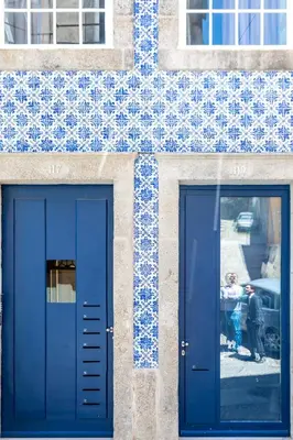 a building with two blue doors and a window at Vitoria Studio Residence II - Downtown in Porto