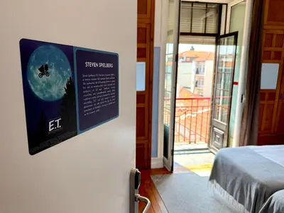 a sign on a wall in a room with a bed at Rivoli Cinema Hostel in Porto
