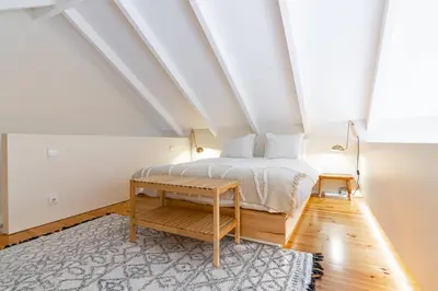 a bedroom with a bed and a table at Casulo Loft - Oporto Downtown in Porto