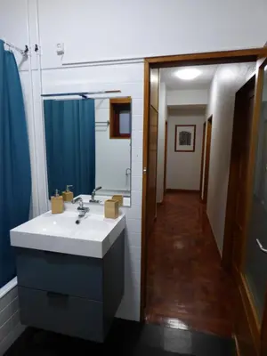 a bathroom with a sink and a large mirror at Boavista YourHome in Porto