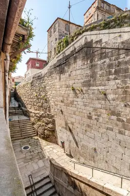 a stone wall with stairs in front of a building at Belomonte 22 Apartments Porto World Heritage in Porto
