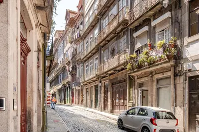 a small car parked on a street in an alley at Belomonte 22 Apartments Porto World Heritage in Porto