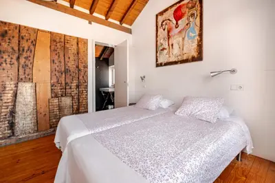 a bedroom with a bed and a painting on the wall at Belomonte 22 Apartments Porto World Heritage in Porto