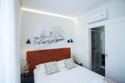a bedroom with a bed with a red headboard at Boavista Premium Family & Business by Porto City Hosts in Porto