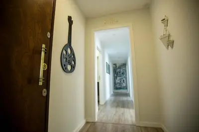 a hallway with a door and a clock on the wall at Boavista Premium Family & Business by Porto City Hosts in Porto