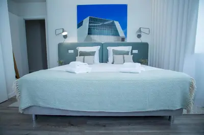 a blue bedroom with a bed with two towels on it at Boavista Premium Family & Business by Porto City Hosts in Porto