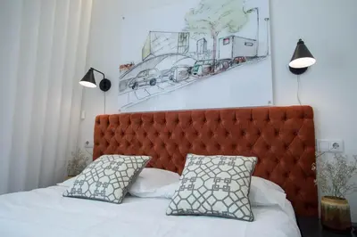a bed with a red headboard and two pillows at Boavista Premium Family & Business by Porto City Hosts in Porto