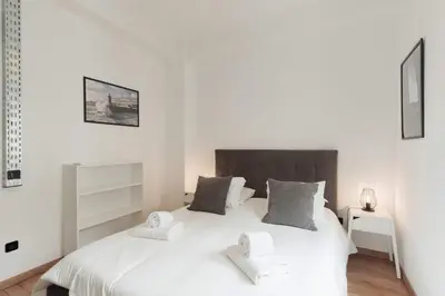 a bedroom with a white bed with two towels at Puro Apartment in Porto