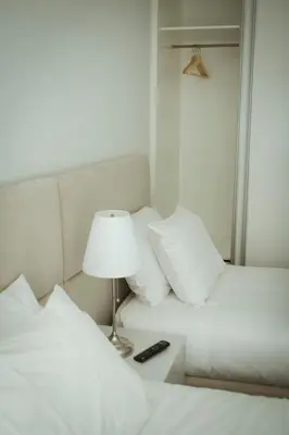 a bedroom with two beds and a lamp on a night stand at Nightingale Apartments in Porto