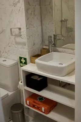 a bathroom with a sink and a toilet at Nightingale Apartments in Porto
