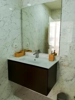 a bathroom with a sink and a mirror at Nightingale Apartments in Porto