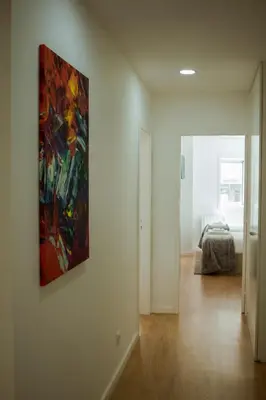 a painting hanging on a wall in a bedroom at Nightingale Apartments in Porto