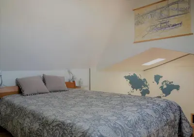 a bedroom with a bed with a map on the wall at InvictaViews Loft in Vila Nova de Gaia