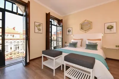 a bedroom with a bed and a balcony at Azulejos Duplex Apartment - Porto Downtown in Porto