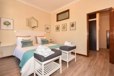 a bedroom with a bed and a table with towels at Azulejos Duplex Apartment - Porto Downtown in Porto