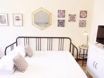 a bedroom with a bed with a mirror on the wall at Azulejos Duplex Apartment - Porto Downtown in Porto
