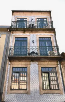 a tall building with windows and a balcony at Azulejos Duplex Apartment - Porto Downtown in Porto