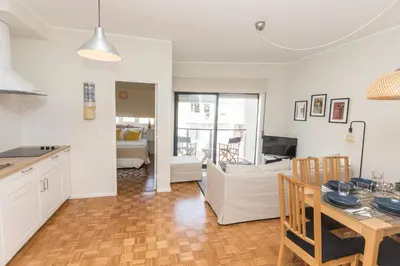 a kitchen and living room with a table and a couch at Porto Haven - Vintage Apartment in Downtown in Porto