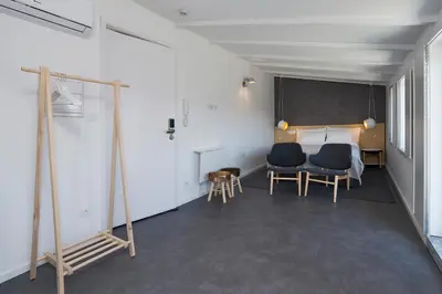a room with two chairs and a table and a chalkboard at Oporto Avenue Attic - Solar da Avenida in Porto