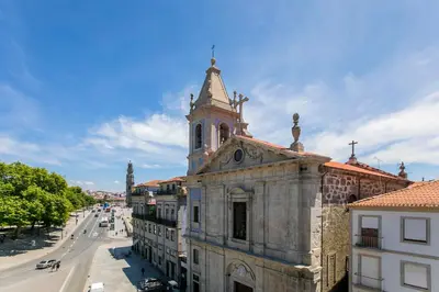 an old building with a clock tower on a street at Casa da Cordoaria by Oporto Soul in Porto